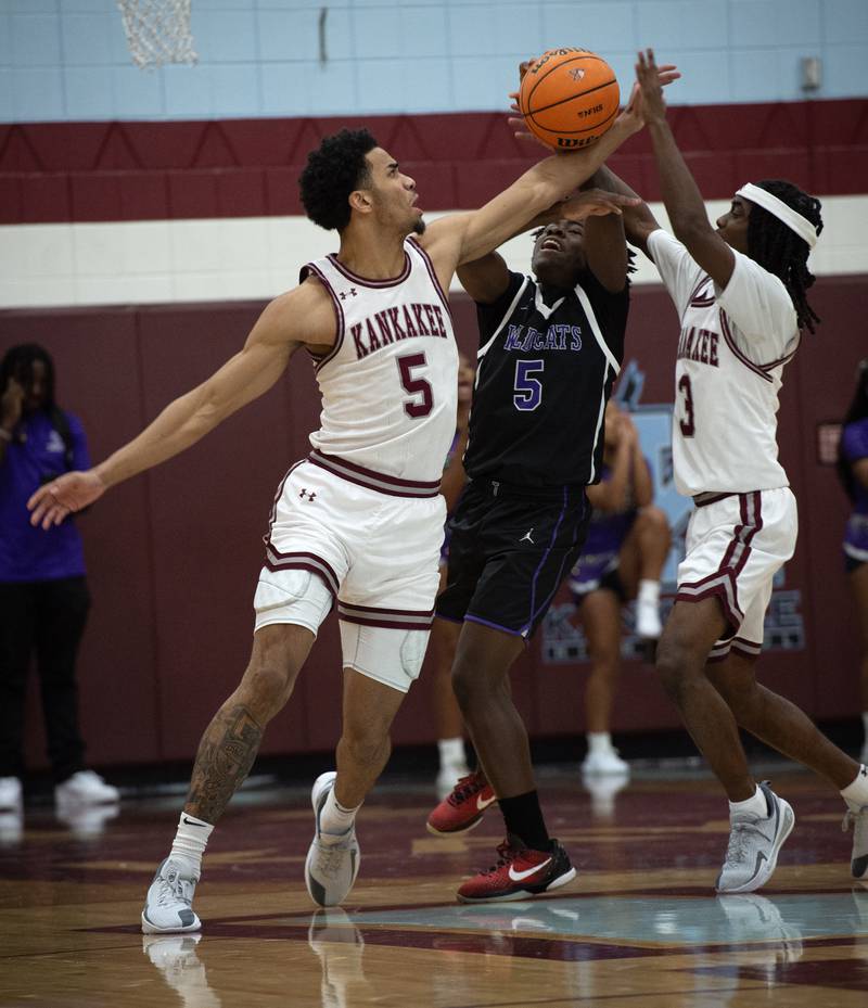 Kankakee's EJ Hazelett, left, and Cedric Terrell III, right, pressure Thornton's DaKari Nesbitt, center, in a game on Friday, December 12, 2025.