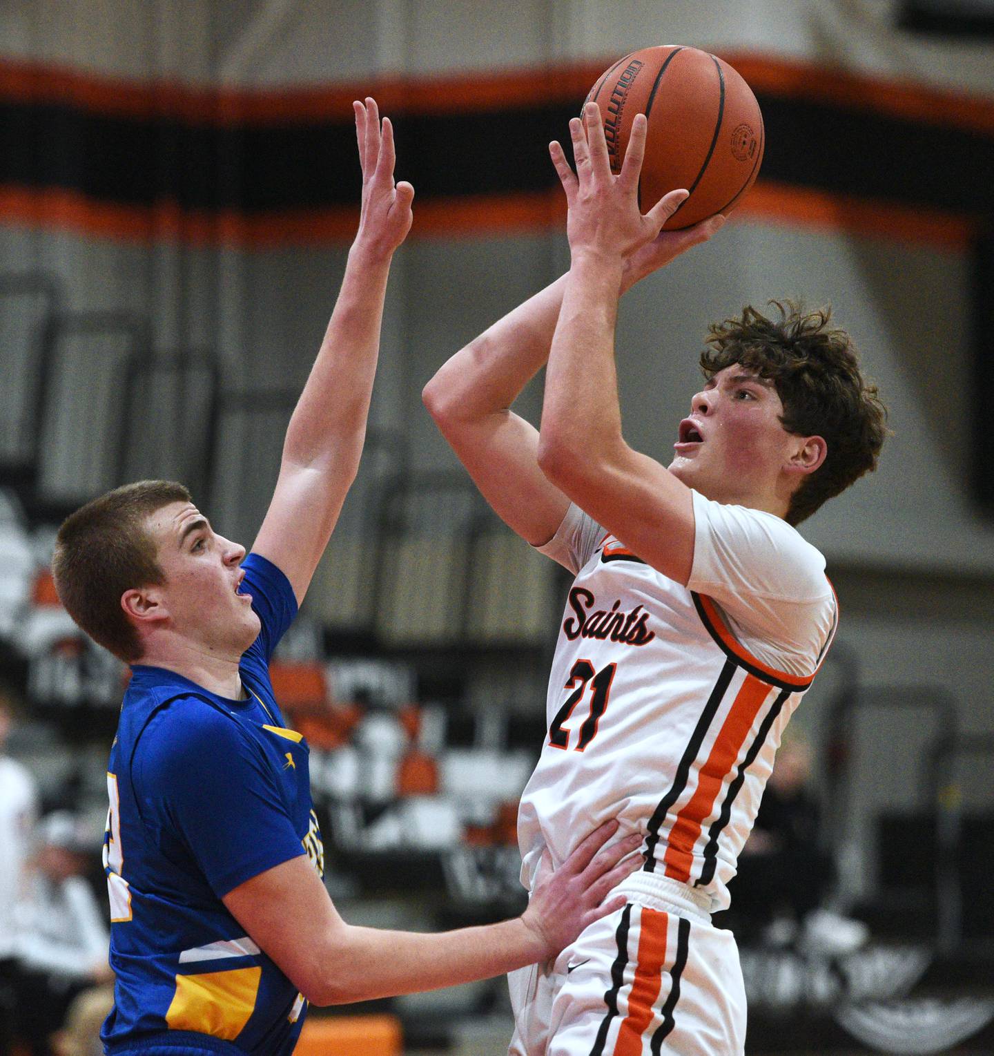 St. Charles East's Jacob Vrankovich (21) takes a shot over Wheaton North's Ben Gillmar during Wednesday’s boys basketball game in St. Charles.