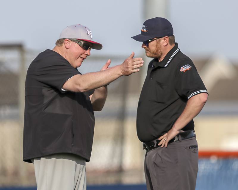 Plainfield North's head coach John Darlington has a discussion with the umpire during baseball game between Plainfield North at Oswego, Thursday, April 24, 2025 in Oswego.