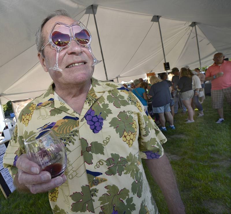 David Battistelli enjoys a glass of wine and watches the entertainment on the main stage at downtown Ottawa's Jordan block during the first day of Wine Fest on Friday, June 3, 2022. The festival continues through Sunday.