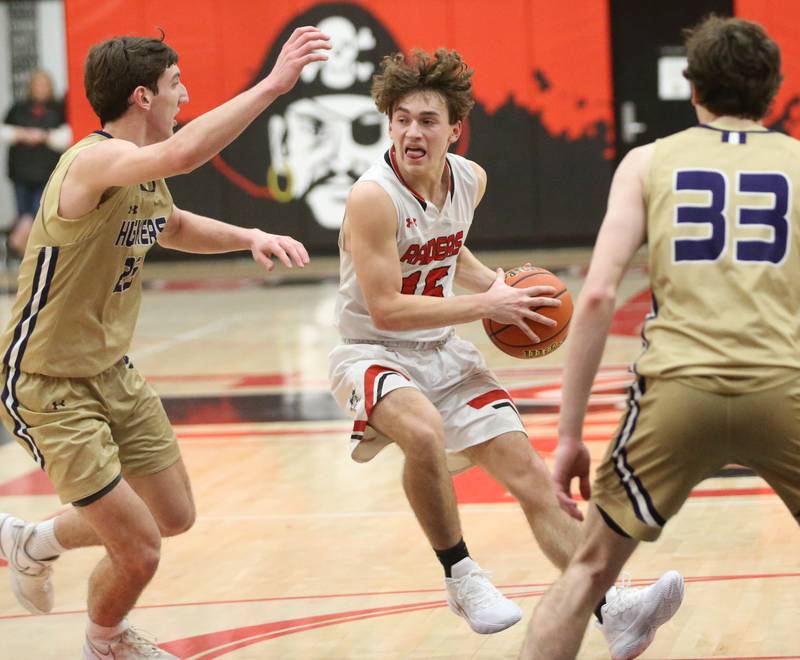 Earlville's Trenton Fruit looks to pass the ball around Serena's Richie Armour and Hunter Staton on Friday, Feb. 9, 2024 at Earlville High School.