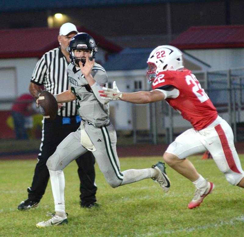 Rock Falls quarterback Connor Fritz is forced from the pocket by Oregon's Ethan Reed on Friday, Sept. 19, 2025 at Landers-Loomis Field in Oregon.