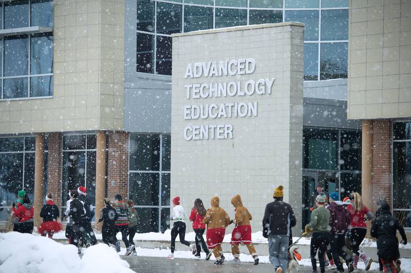 Runners run in front of the college in the 35th annual Jingle Bell Run at Kankakee Community College on Sunday, December 7, 2025.