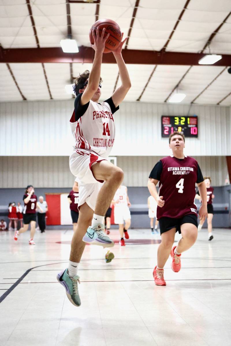Princeton Christian Academy's Santy Slevin takes in a first-half layup in Tuesday's game vs. Ottawa Christian Academy at Howard Hoffman Memorial Gym. The Eagles won 57-42.