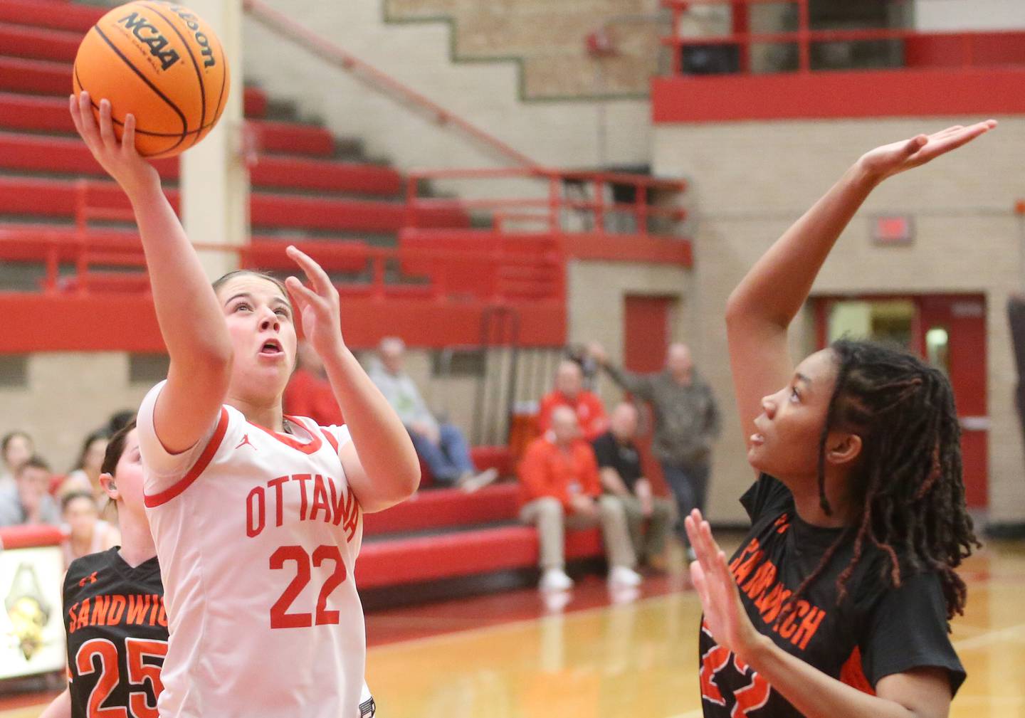 Ottawa's Marlie Orlandi eyes the hoop while taking a jump shot over Sandwich's Alaya Harris on Monday, Jan. 27, 2025 in Kingman Gym at Ottawa High School.