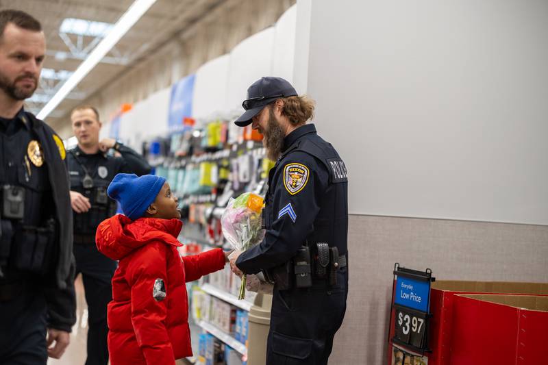 Dixon police officer Jake Muntean discusses gift options with his 7-year-old shopper during Shop with a Cop on Saturday, December 14, 2024 at the Dixon Walmart. Each kid was allowed to spend up to $175 during the shopping excursion with their officer.
