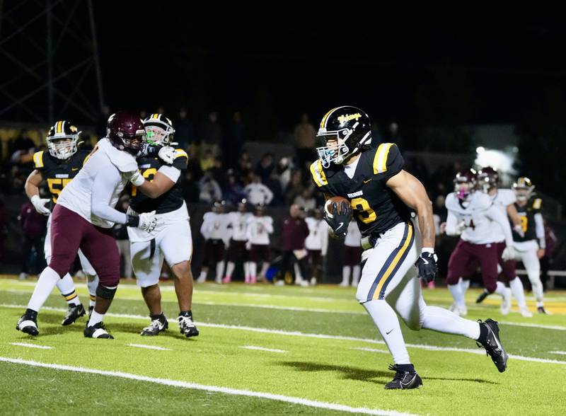 St. Laurence's Sean Rice runs with the football.