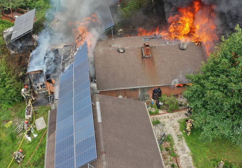 Firefighters respond to a fully-engulfed structure fire in the 500 block of North 2782nd Road on Monday, July 21, 2025 in La Salle. FIre departments from Utica, Wallace, Naplate, Spring Valley, Mendota, Troy Grove, La Salle, Peru, Oglesby and Tonica responded to the scene. Fire crews were dispatched at 9:45 a.m. La Salle Police and La Salle County Sheriff were also on the scene.