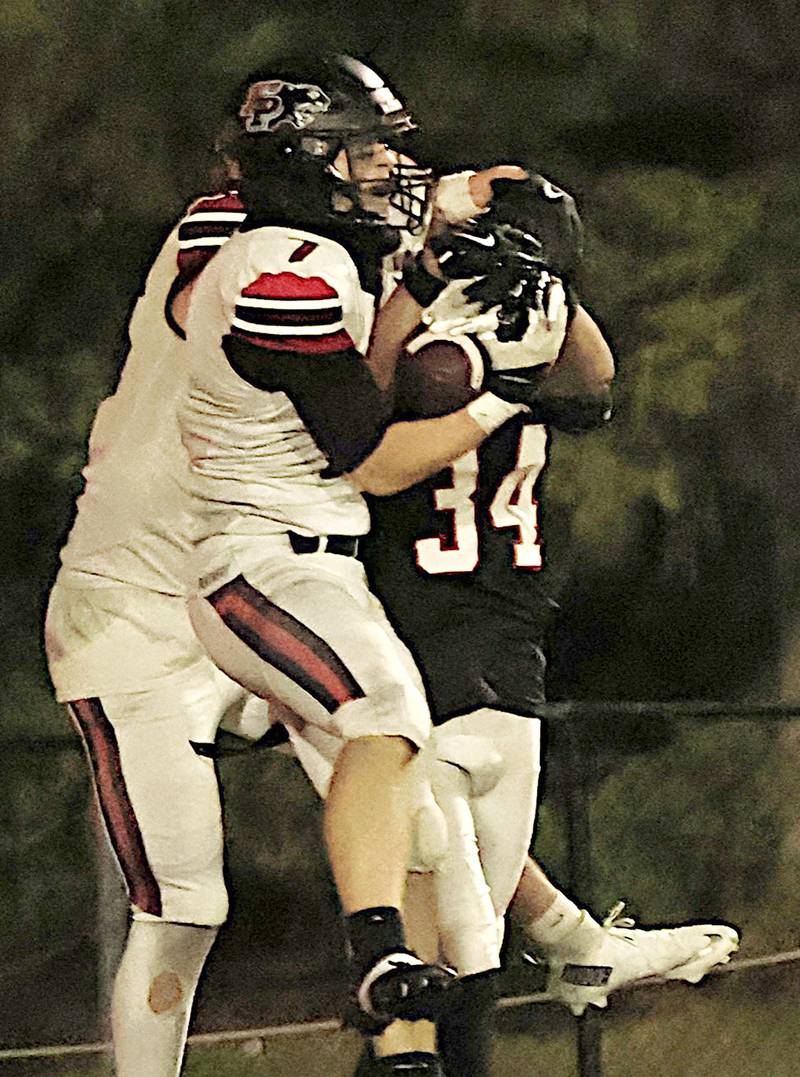 Erie-Prophetstown’s Gaven Adams fight for the catch against Aurora Christians Carson Moreno in the end zone to get the Panthers 2nd touchdown of the night on Saturday, Nov. 1, 2025, during the IHSA 2A 1st round playoff game. The Panthers lost to the hosting Eagles 37-12 .