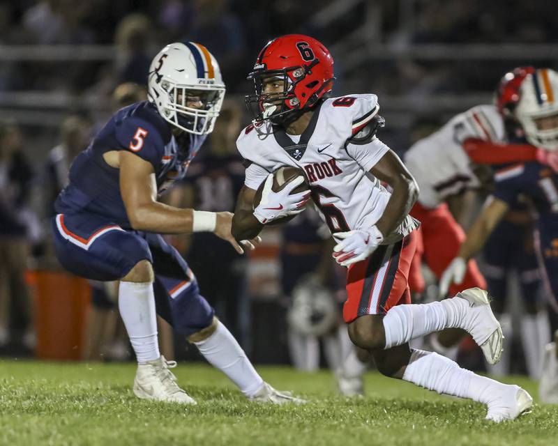 Oswego's Trent Epley (6) runs back a punt during football game between Bolingbrook at Oswego Friday, Sept 12, 2025  in Oswego.