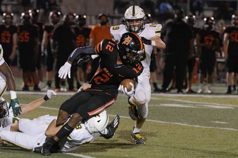 DeKalb's Ethan McCarter (12) makes some yardage against Waubonsie during a game in DeKalb on Friday, Oct. 1, 2021.