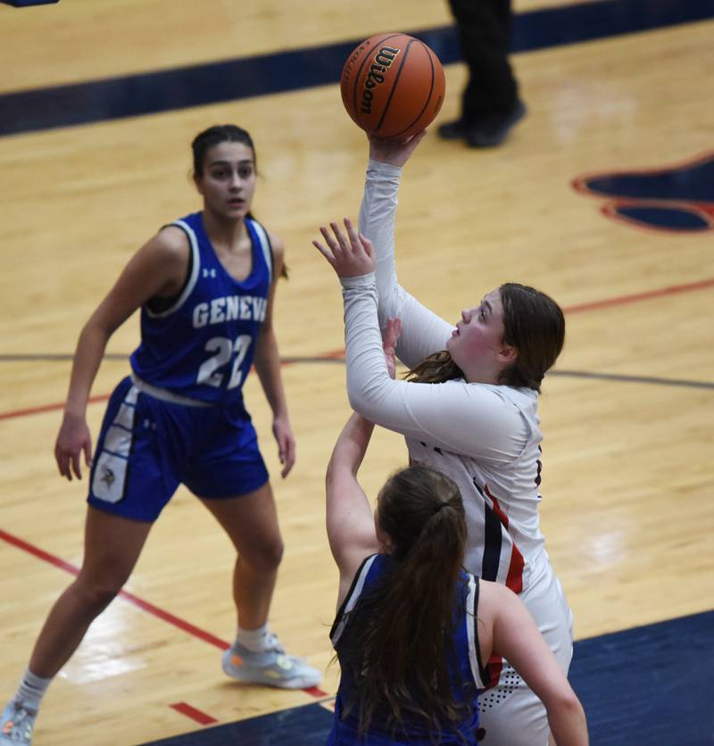 Conant's Kristina Tierney takes a shot past Geneva's Leah Palmer (22) during Friday’s IHSA Class 4A girls basketball regional championship in Hoffman Estates.