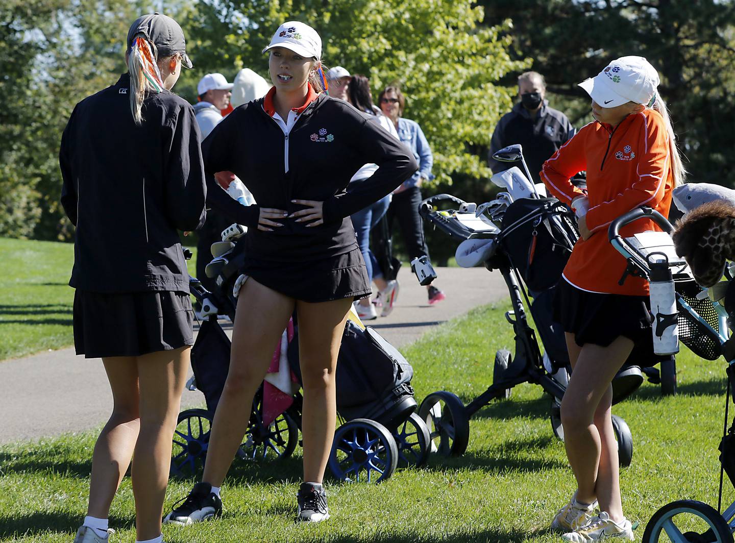 Crystal Lake Co-op’s Madeline Trannel, (left)  Delaney Medlyn (center) and Rylee Run  talk as they wait to hit on the eighth hole during the IHSA Class 2A Huntley Girls Golf Regional on Tuesday, Oct. 1, 2024, at Pinecrest Golf Club in Huntley.
