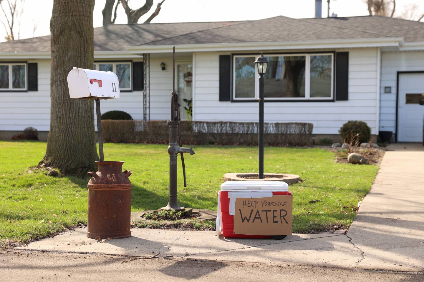A cooler offering free water sits in the driveway of a home in Aroma Park on Thursday, March 12, 2026, just a couple blocks from the areas of major damage caused by the March 10 tornado.