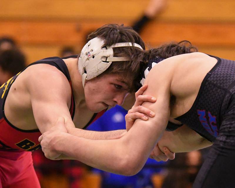 Aidan Huck of Batavia, left, goes head to head with Marmion Academy wrestler Ashton Hobson where Aidan took the win during the regional title match in the 144 weight class held on Saturday Feb. 3, 2024 at Glenbard West High School.