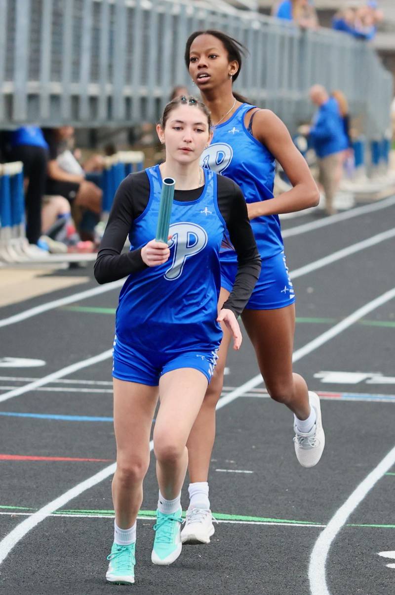 Princeton's  Kinley Fogarty takes the baton from Kieara Knupp in Thursday's Howard-Monier Meet at Princeton.