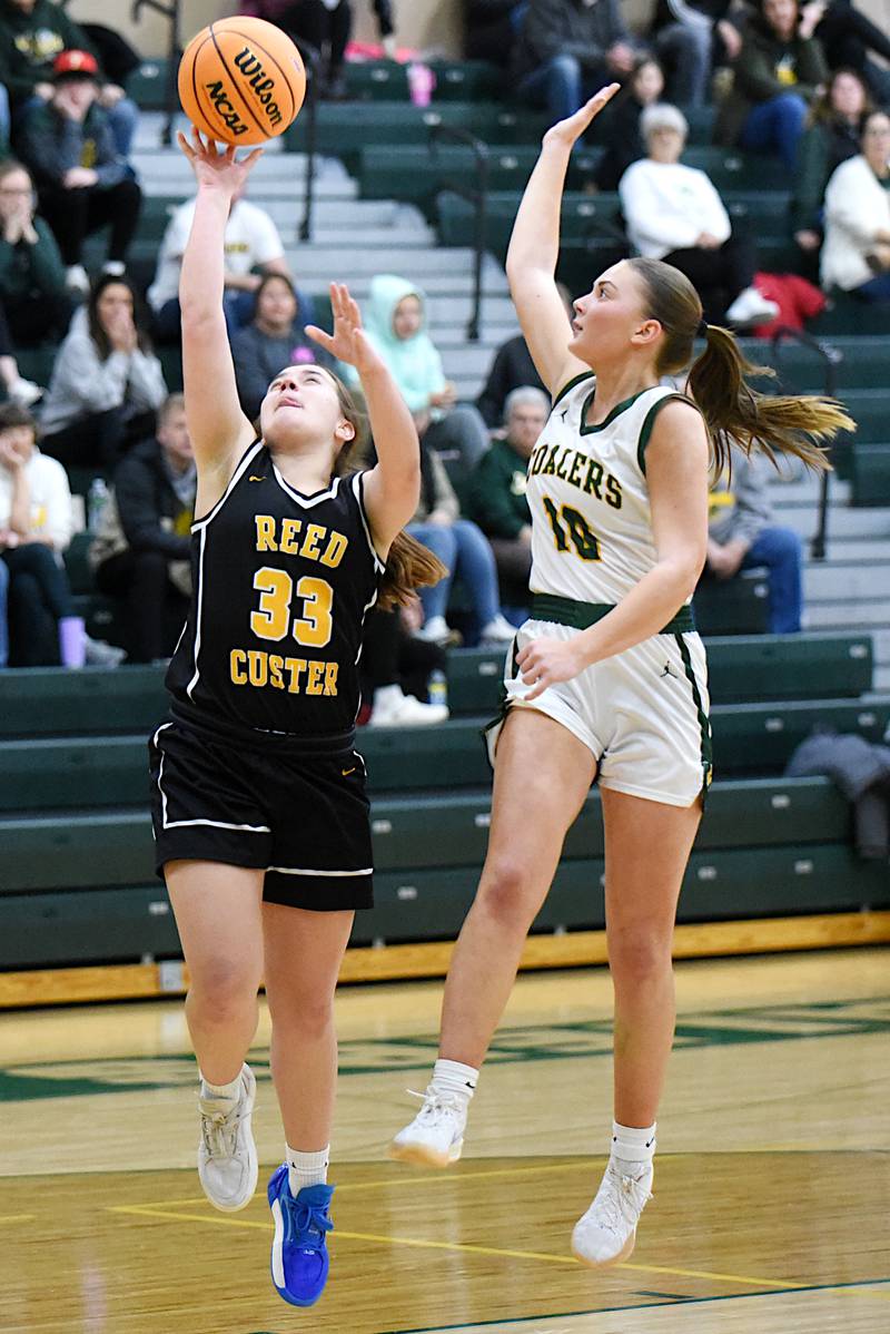 Reed-Custer's Leah Grace, left, lays it up as Coal City's Kylee Kennell defends during an IHSA Class 2A Coal City Regional semifinal Tuesday, Feb. 18, 2025.