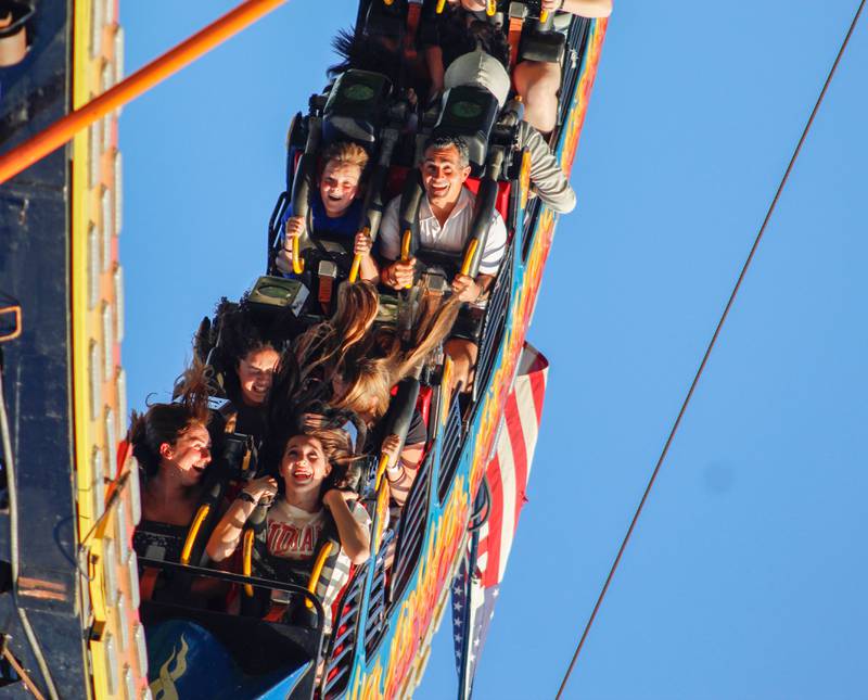 Attendees of the Downers Grove Rotary GroveFest laugh while riding the "Ring of Fire" ride, on Thursday, June 19, 2025.