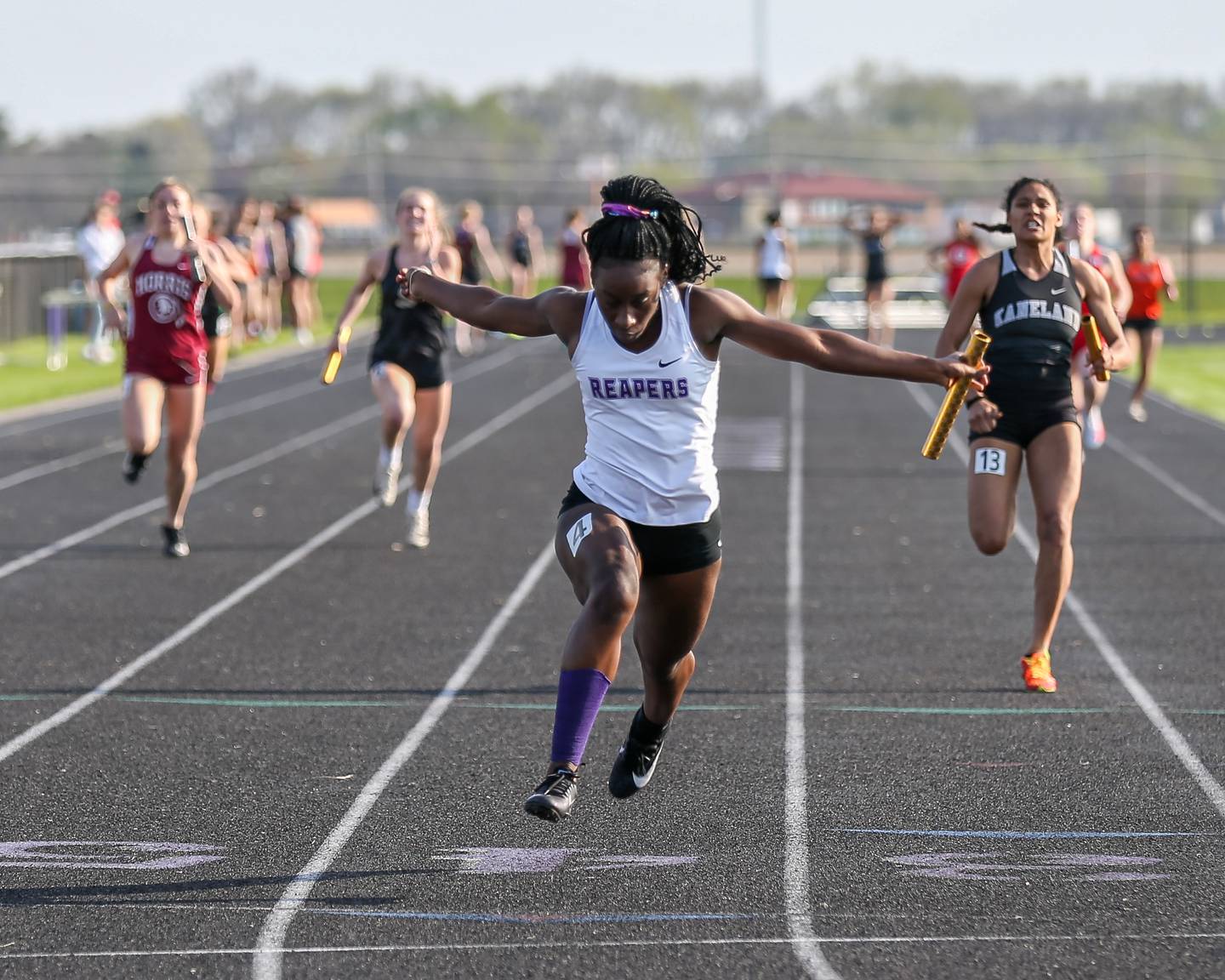Plano's Armoney Clay anchors for the win in the 400 X 100 relay during the Interstate Eight conference meet at Plano High School.