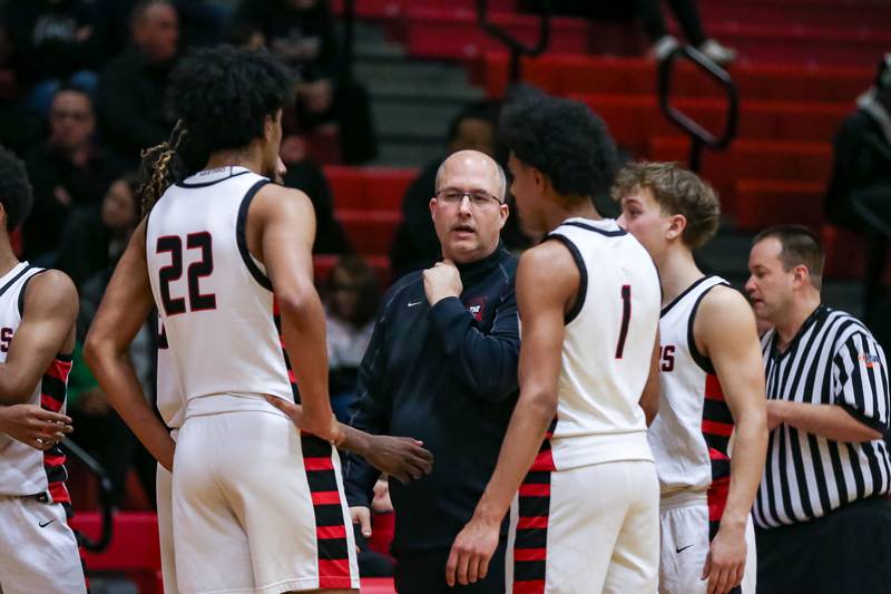 Bolingbrook's head coach Rob Brost instructs the team during a timeout in their basketball game between Plainfield North at Bolingbrook, Friday Dec 13, 2024 in Bolingbrook.