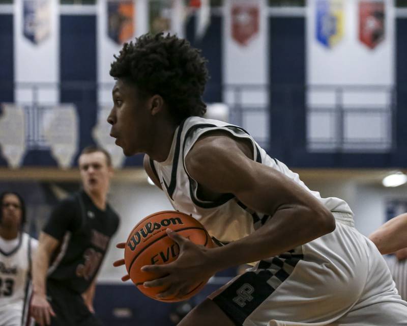 Oswego East's Dshaun Bolden (24) drives baseline to the basket during their basketball game between Plainfield North at Oswego East Friday, Dec 5, 2025 in Oswego.
