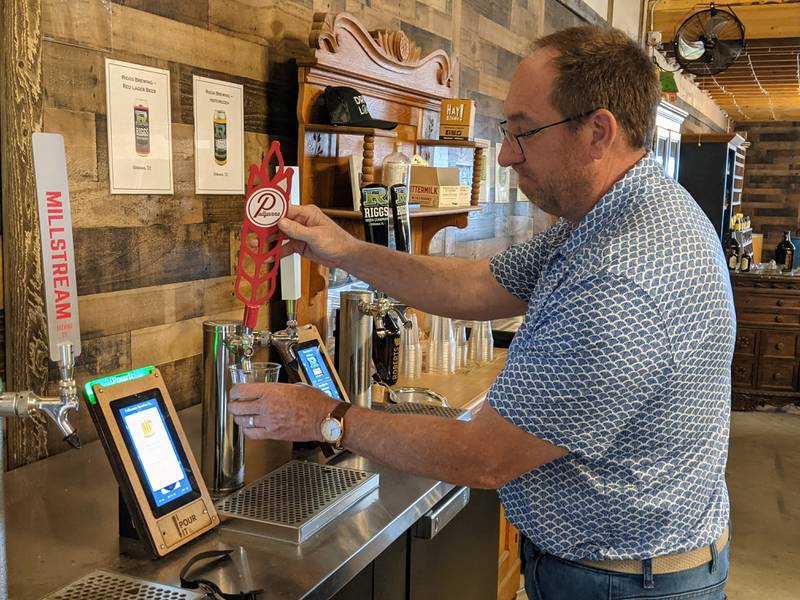 Roberts Family Farm owner Joe Roberts demonstrates the farm's new self-serve beverage station. He owns Roberts Family Farm with his wife, Jennifer. A grand opening for the beverage station will take place on June 7.