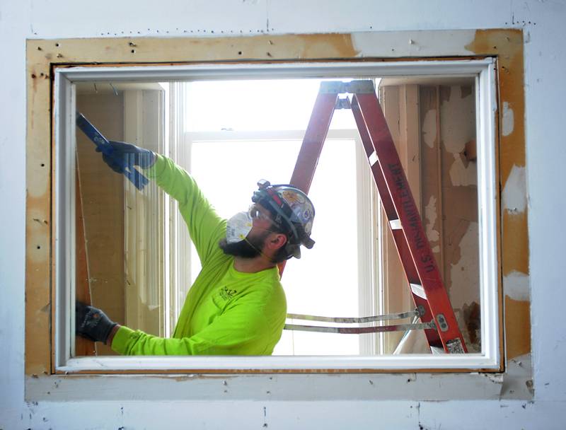 Jonathan Alvarez of USD, a demolition company, works on the demolition of a wall in the Old Courthouse and Sheriff’s House in Woodstock on Tuesday, March 1, 2022, as the renovation of the building continues.