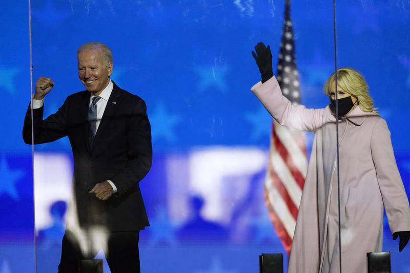 Democratic presidential candidate former Vice President Joe Biden and his wife Jill Biden wave to supporters, Tuesday, Nov. 3, 2020, in Wilmington, Del. (AP Photo/Andrew Harnik)