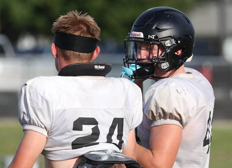 Sycamore’s Kevin Lee (left) and Cooper Bode talks after a scrimmage with Lena-Winslow Thursday, July 24, 2025, during a joint practice with Byron, Lena-Winslow and Sycamore at Sycamore High School.