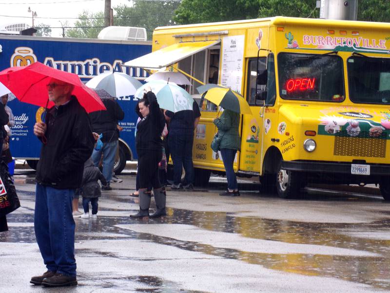 Plenty of Streator Food Truck Festival goers came equipped with umbrellas for the first couple hours Saturday, May 21, 2022.
