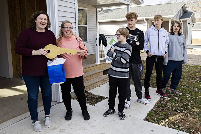 Kaitlyn Nease (left) presents Heather Dingley with the key to her new Habitat for Humanity home Sunday, Nov. 20, 2023. Dingley will share the home with sons Parker, 12, Peyton, 16, Blake, 14, and Julian 19. This is the 30th home Habitat has built in Dixon.