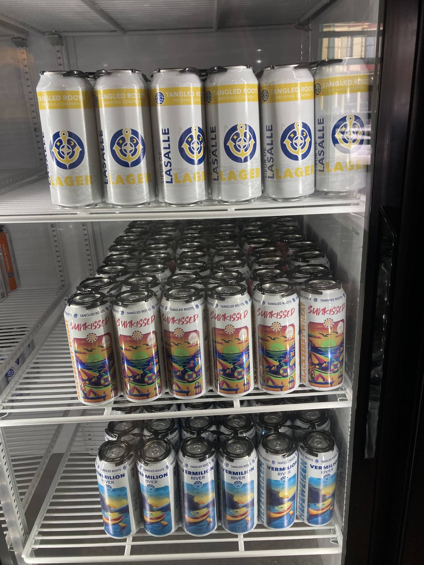 Cans of Tangled Roots Brewing Company beer for takeaway purchase at Lock & Mule restaurant on State Street in Lockport. Tues., Feb. 11, 2025.