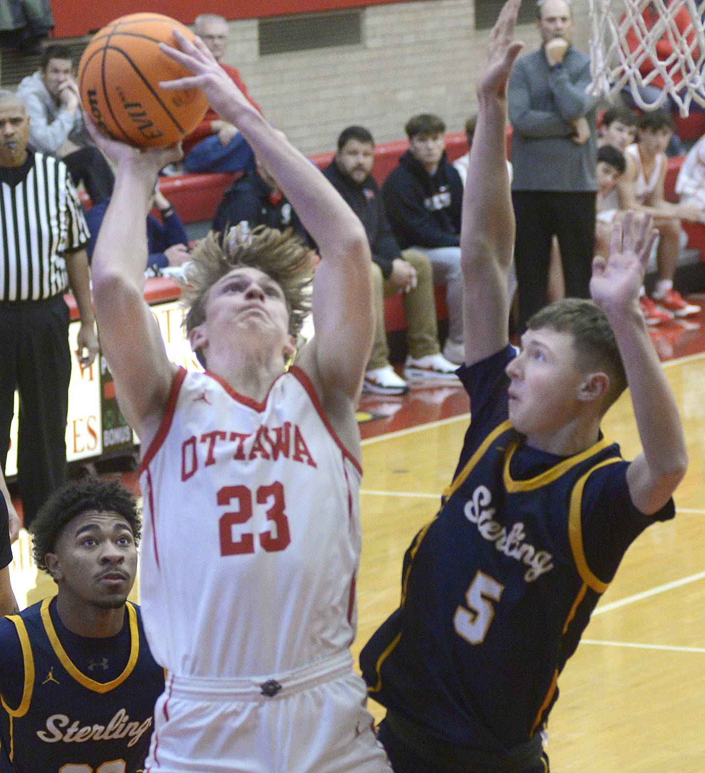 Ottawa’s Owen Sanders works this shot to the basket between Sterling’s Bryce Hartman (5) and Kaedon Phillips in the 1st period Friday during the Dean Riley Shootin’ The Rock Thanksgiving Tournament.