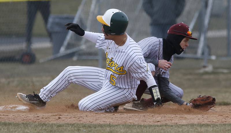 Crystal Lake South’s Yandel Ramirez slides into third base as Richmond-Burton’s Johnny Larsen fields the ball during a nonconference baseball game Friday, March 24, 2023, at Crystal Lake South High School.
