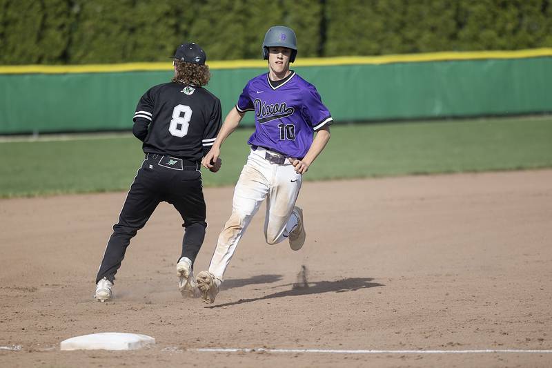 Dixon’s Bryce Feit scampers into third against Rock Falls on Tuesday, April 18, 2023.