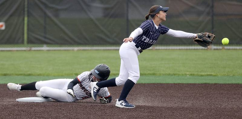 McHenry's Danica McCarthy slides into second base as Cary-Grove's Olivia Osadzinski tries to field the throw during a Fox Valley Conference softball game on Thursday, April 30, 2026, at McHenry High School.