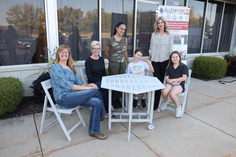 Donna Riedlage, left, and her Allen Force family poses for a photo at their soon to be opened Recreation Center in Joliet on Thursday, Oct. 10, 2024.