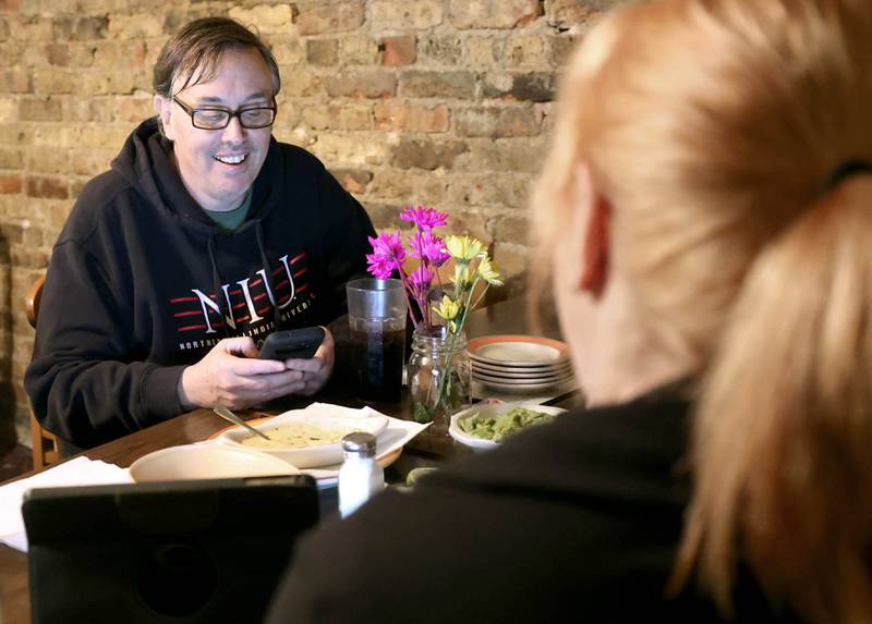 Scott McAdams, running to retain his seat on the city council in DeKalb’s 5th Ward, smiles with supporters as checks his phone for election results Tuesday, April 4, 2023, during an election night watch party at Rosita's Mexican Restaurant in DeKalb.