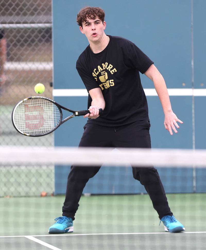 Sycamore’s Liam Kerbel hits a forehand during his number one doubles match along with partner Jonathan Locascio against Dixon Thursday, March 30, 2023, at Sycamore High School. This is the inaugural season for the Sycamore boys tennis team.
