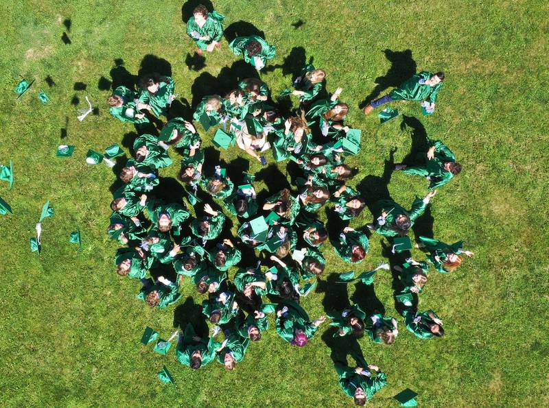 St. Bede graduates throw their caps in the air after the graduation ceremony on Sunday, May 21, 2023 at St. Bede Academy.