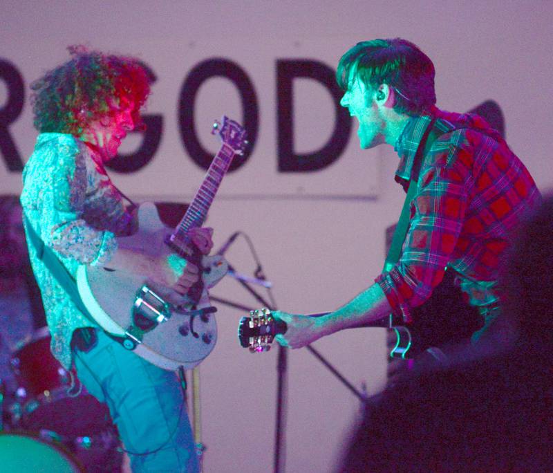 Two members of Fortunate Sons, a Creedence Clearwater tribute band,, interact as they play their guitars during the Jamboree Concert Series in Mt. Morris on Friday, Aug. 29, 2025.