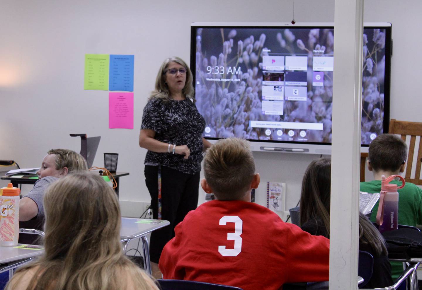 Janell Hartman, a sixth-grade teacher at West Carroll Middle School in Mount Carroll, boots up her classroom video board to go over class schedules with her students on the first day of school on Wednesday.