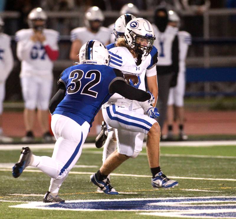 Geneva’s Finnegan Weppner makes a catch before being tackled by St. Charles North’s Riley Sprindis during a game in St. Charles on Friday, Oct. 20, 2023.