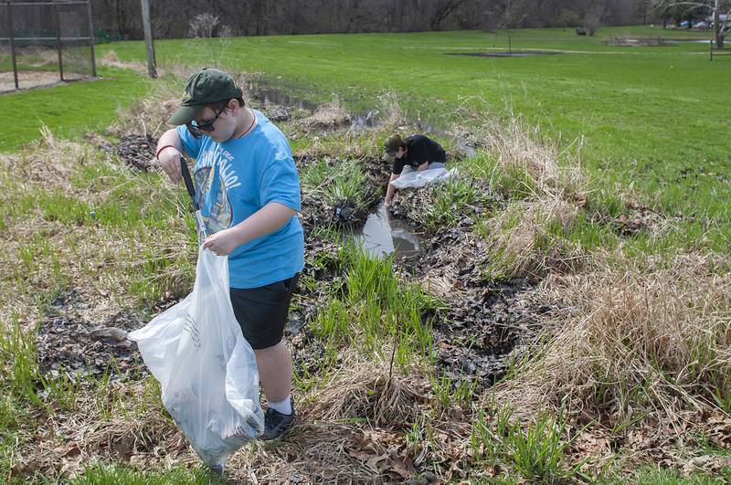 Jude Eilers, 11, gathers up refuse at Centennial Park on Saturday as part of an Earth Day clean up event organized by the Rock River Development Authority.