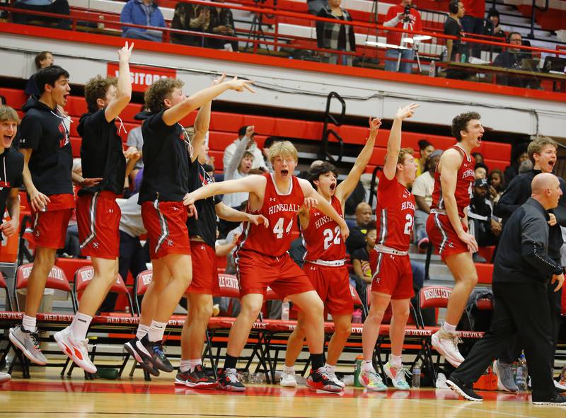Hinsdale Central's bench reacts to a three-pointer by Emerson Eck during the Hinsdale Central Holiday Classic championship game between Oswego East and Hinsdale Central high schools on Thursday, Dec. 29, 2022 in Hinsdale, IL.