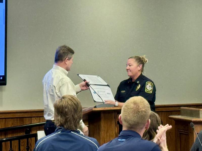 Vice Chair for Employer Support of the Guard and Reserve Michael Holub presents Chief Sarah Raymond with the Patriotic Employer Award during Monday's Peru Council meeting.