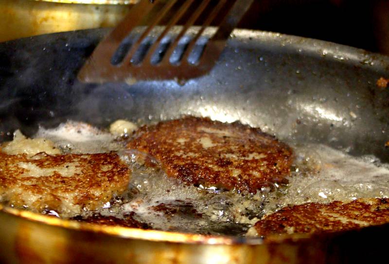 Latkes are fried during a Chanukah party at The McHenry County Jewish Congregation Sunday.