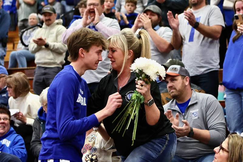 PHS junior Jackson Mason and his mom, Heather, share a special moment before Friday's game at Prouty Gym. His dad, Pat, passed away unexpectedly on Monday. Each team member presented Heather with a carnation and PHS took a moment of silence in Pat's honor.
