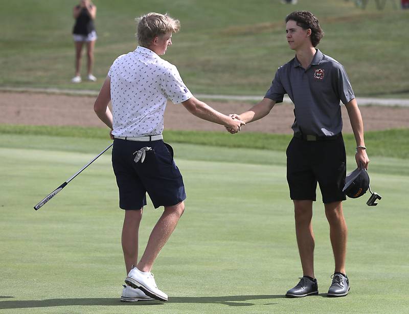 Rochelle's Ian Metzger shakes hands with Crystal Lake Central’s Asher Johnson on the 18th green after Metzger won the IHSA Class 2A Crystal Lake South Boys Golf Regional on Wednesday, Oct. 1, 2025 at RedTail Golf Club in Lakewood.