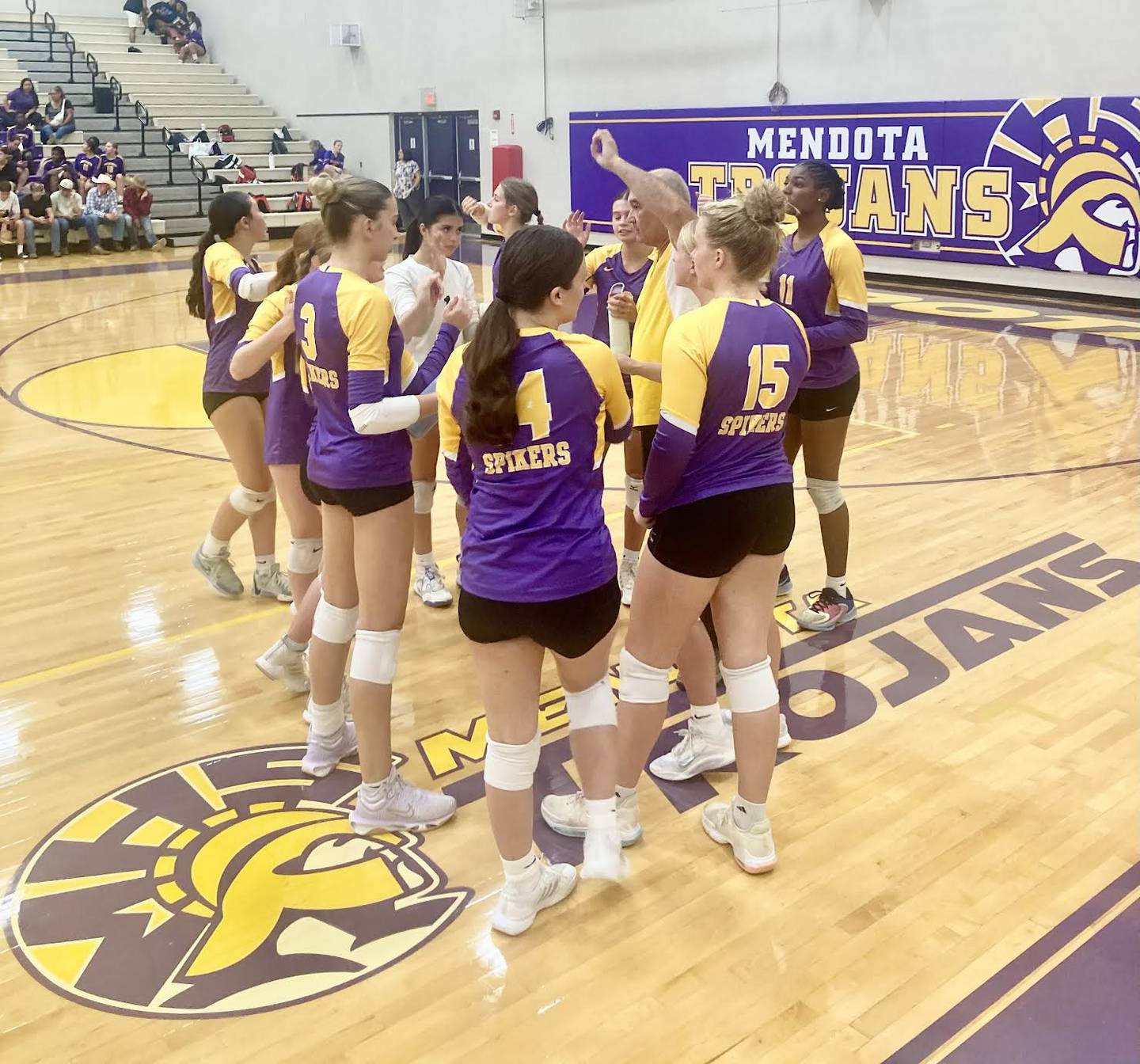 Mendota coach Demi Salazar rallies the troops between sets of Tuesday's home match with Princeton.